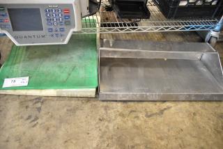 3 items including 2 green cutting boards with visible wear and a metal shelf on a concrete floor with a label marked "73 QTY VX 3".