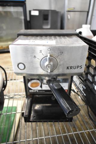 Krups XP524 espresso machine with portafilter. Stainless steel, single group. Item shows minor wear. 120V, 1 Phase.