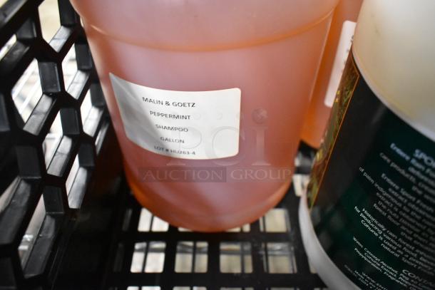 6 jugs including Malin & Goetz Peppermint Shampoo gallon, visible label with lot #HU263-4, in good condition.
