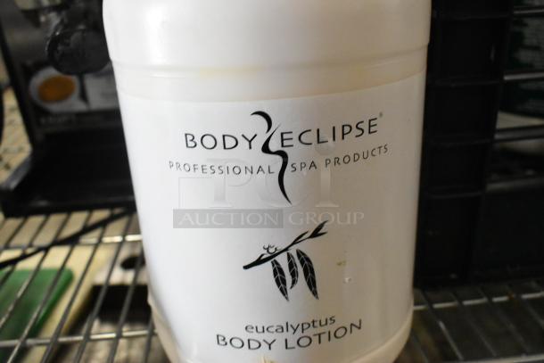 Body Eclipse eucalyptus body lotion jug, labeled "Professional Spa Products," on a shelf; well-preserved condition.
