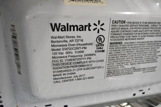 Walmart EM720C2WT-PM countertop microwave oven, 120V, 1050W, 2450MHz, with plate. Model info and safety labels visible.