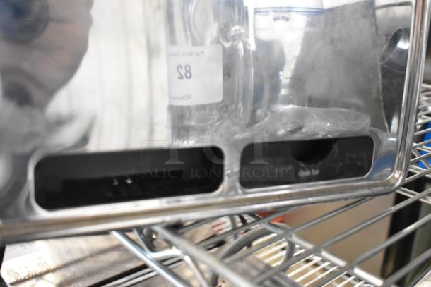 Hamilton Beach 4 slot metal toaster, countertop model, 115V, visible wear, situated on a wire rack.