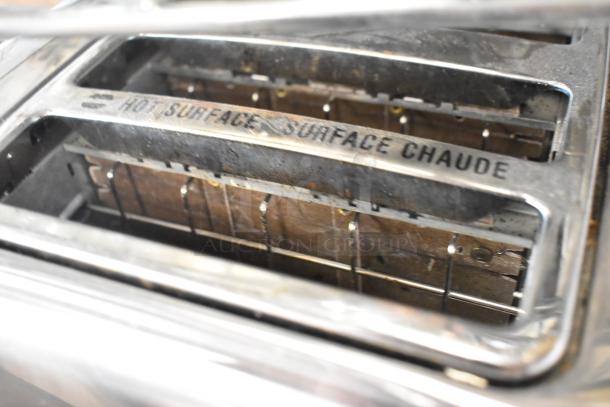 Hamilton Beach Metal 4-Slot Toaster, 115V, 1 Phase. Visible wear, "Hot Surface" label. Durable countertop appliance.