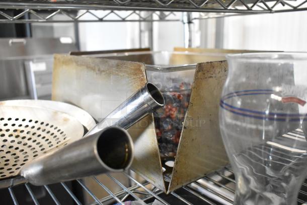 Lot of various items including a metal ice scoop, strainer, and glass with red and blue markings. Items appear used.