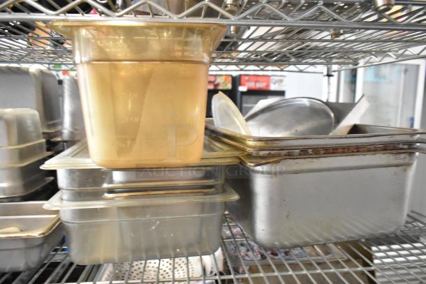 Various poly and stainless steel drop-in bins stacked on a metal shelf, showing light wear and suitable for kitchen use.