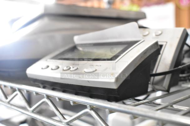 Two RadioShack Caller ID devices on a metal shelf; visible buttons and slightly used condition.
