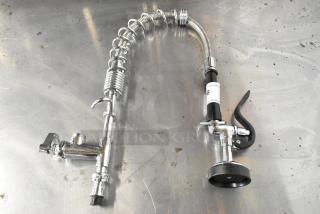 Metal spray nozzle attachment with chrome finish, flexible hose, and ergonomic handle. Appears in excellent condition.
