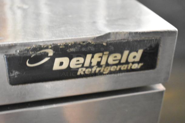 Delfield UCD4432N-9M-DD1 stainless steel prep table, 2 drawers, 1 missing. 115V, 1 phase. Visible Delfield label.