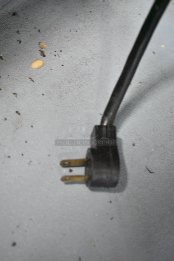 Power cord for Delfield UCD4432N-9M-DD1 prep table, 115 volts, 1 phase. Surface shows wear with scattered debris.