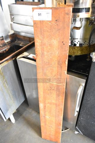 Wooden butcher block cutting board, rectangular, worn surface with visible scratches, auction label "91".