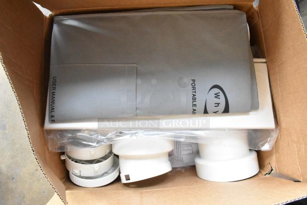 Brand new Whynter ARC-14S dual hose portable air conditioner in original packaging, visible manual, accessories included.