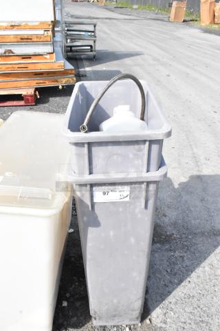 Gray Poly Slim Jimi trash can, scratch and dent condition, with hose and container inside. Auction label visible on front.