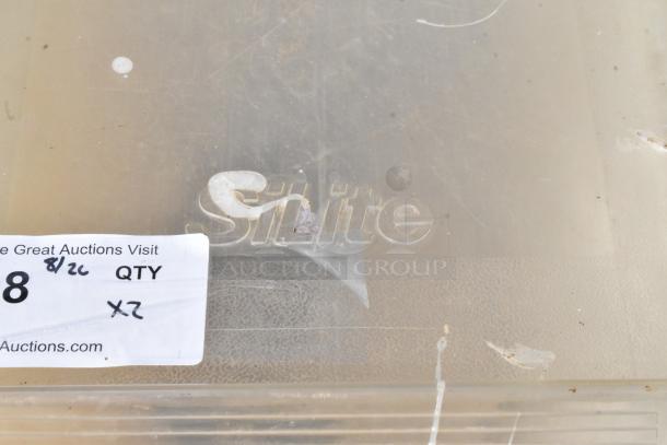 Transparent Silite poly ingredient bin with commercial casters, marked with auction label, appears lightly used.