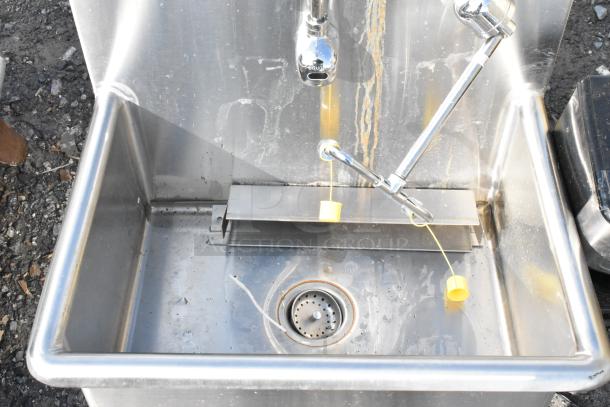 Eagle stainless steel single bay sink, no legs, visible faucet fixtures, some wear marks, includes drain strainer.
