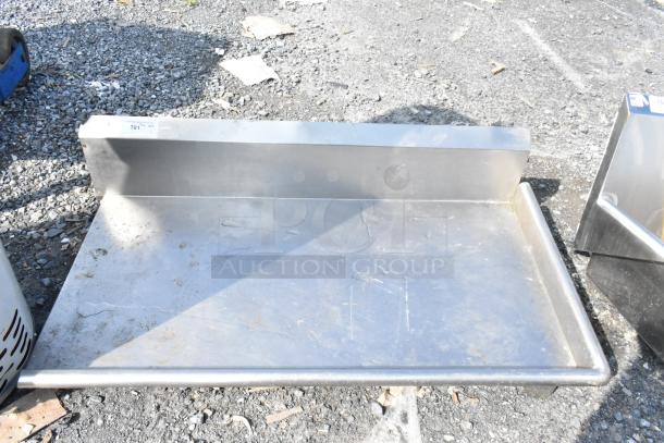 Stainless steel right side dishwasher table, no legs, used condition, with a raised backsplash and smooth surface.