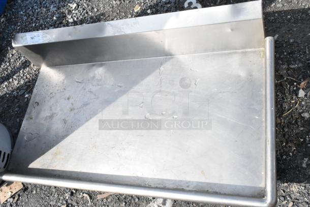 Stainless steel right side clean side dishwasher table without legs, minor wear, features raised back splash.