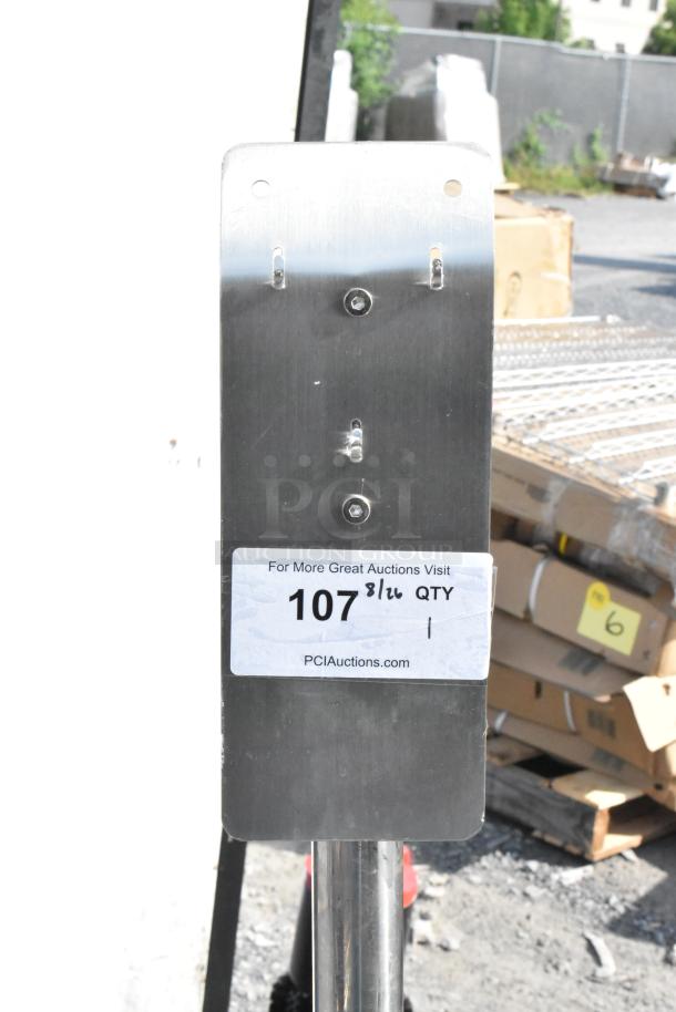 Metal stand with a rectangular silver plate, visible label indicating "PCI Auctions" and item number "107."
