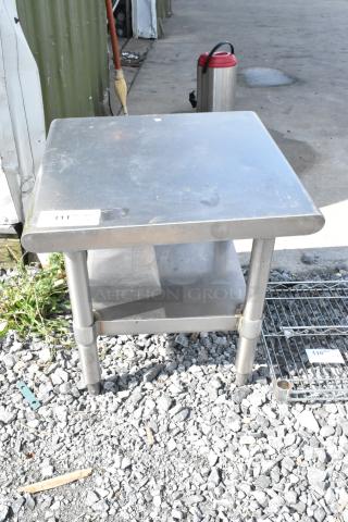 Stainless steel commercial equipment stand with metal under shelf, used condition, item tag 111 visible on top.