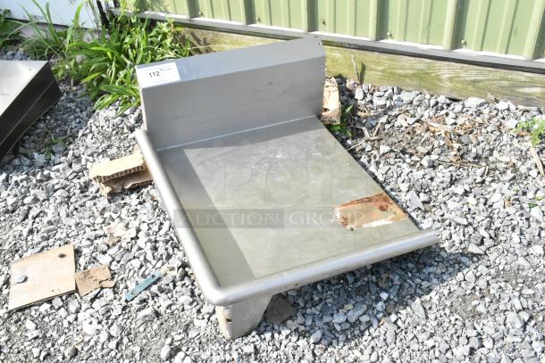Stainless steel left side clean side dishwasher table, no legs, showing minor wear, labeled "112," ideal for kitchen use.