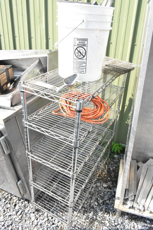 Chrome finish 5-tier wire shelving unit, good condition, requires dismantling. Consider freight charges for shipping.