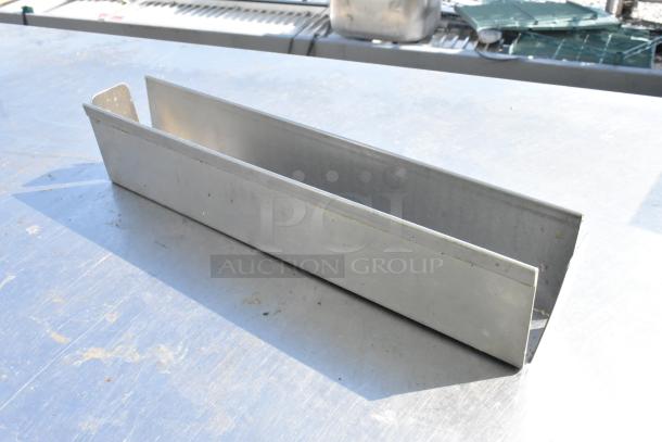 Metal bracket with straight edges, used, displaying minor surface wear. Part of a lot of 11 metal pieces.