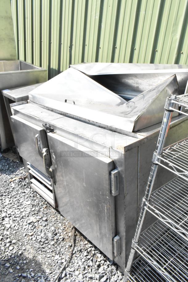 Universal Coolers SC48BM stainless steel sandwich salad prep table, commercial grade, 115V, visible wear, outdoor setting.