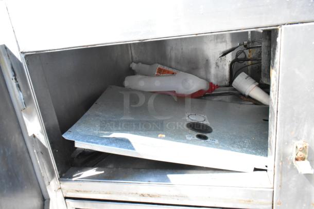 Universal Coolers SC48BM stainless steel prep table interior, showing shelf and bottles. Used condition, 115V, 1-phase.