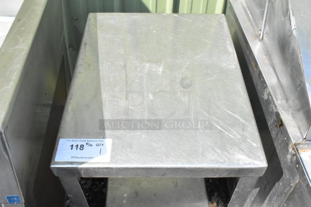 Metal table with under shelf, used condition, visible surface scratches, auction tag "118" and "PCIauctions.com."