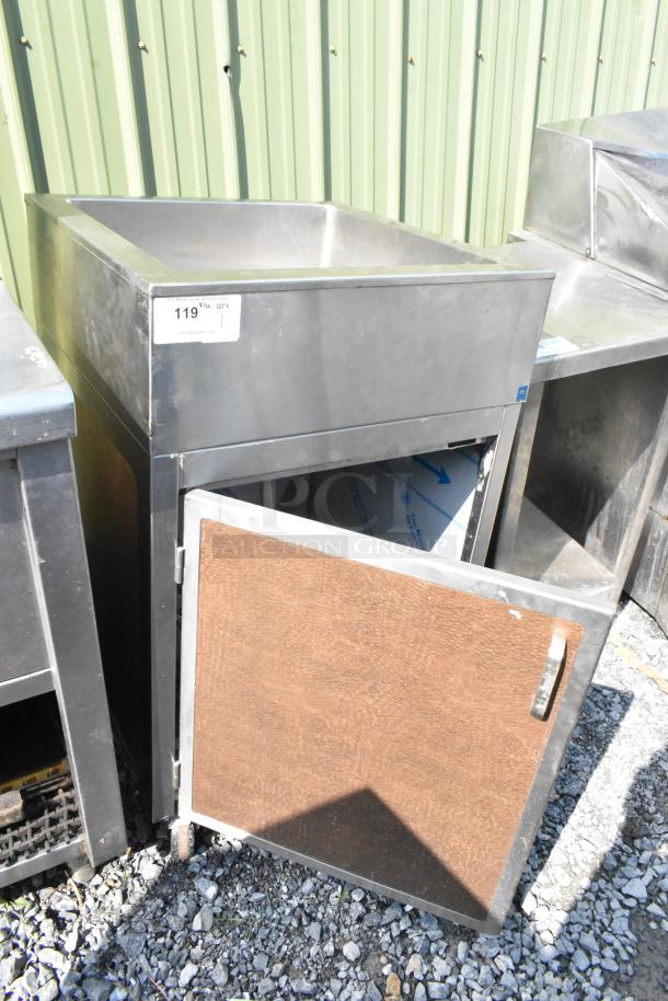 Stainless steel ice bin with open door; door does not stay closed. Labels indicate auction info. Used condition.