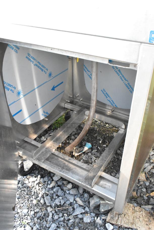 Stainless steel ice bin with visible components, on casters. Notable condition: door does not stay closed.