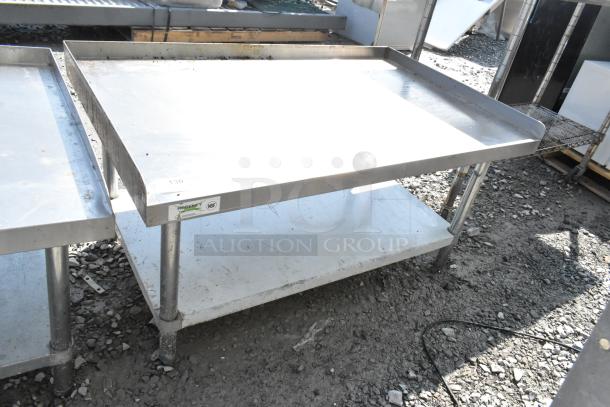 Regency 600ES3048G stainless steel equipment stand with metal undershelf, minor wear; NSF-certified and durable for kitchen use.