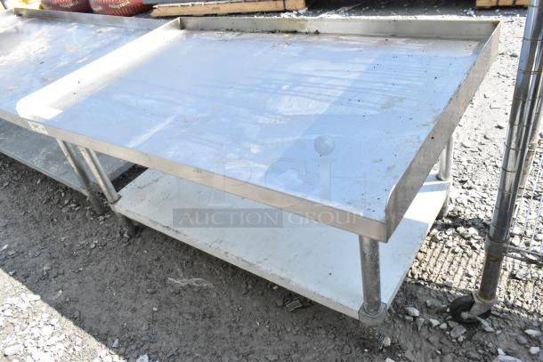 Regency 600ES3048G stainless steel equipment stand with metal under shelf; good condition, some surface wear visible.