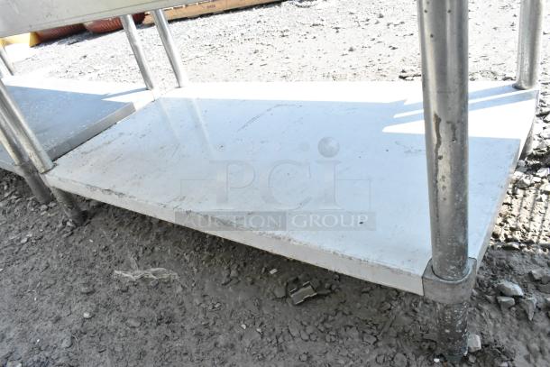 Regency 600ES3048G stainless steel equipment stand with metal undershelf. Features sturdy legs, showing signs of wear.