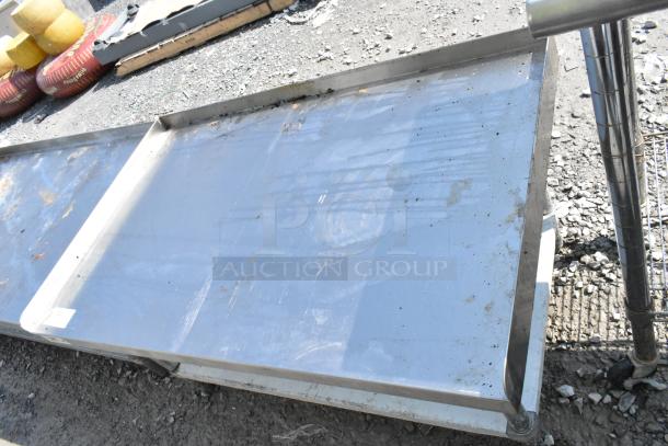 Regency 600ES3048G stainless steel equipment stand with metal under shelf, showing moderate wear, suitable for commercial use.