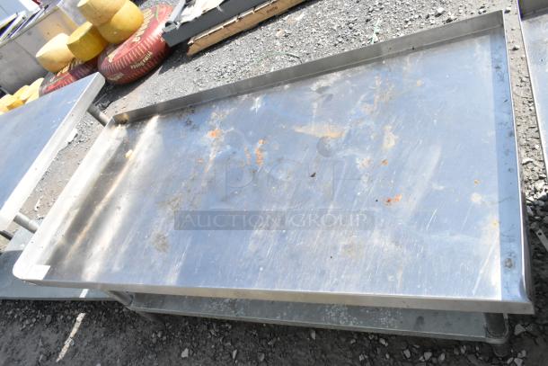 Regency stainless steel equipment stand with metal under shelf, showing signs of wear and rust on the surface.