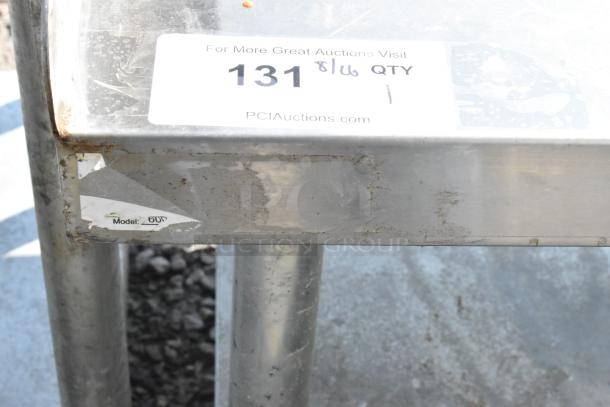 Regency stainless steel equipment stand with metal under shelf, visible wear and model number sticker.