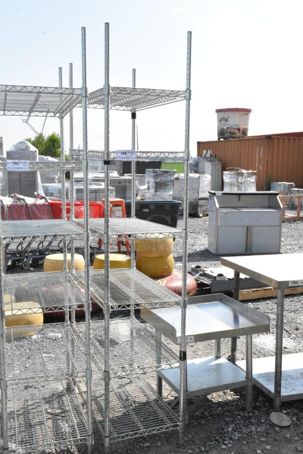Chrome finish 6-tier wire shelving unit in good condition, located outdoors. Buyer must dismantle; tags indicate item numbers.