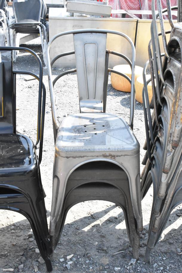 Black/gray metal Tolix-style chair, durable design, stackable. Slightly worn; part of 19-chair auction lot.