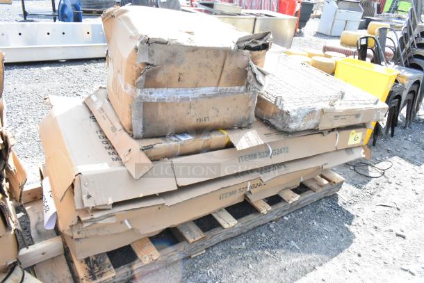 Damaged boxes on pallet labeled with item numbers, including 522SG2472. May contain new scratch and dent stainless steel equipment stands and work tables.