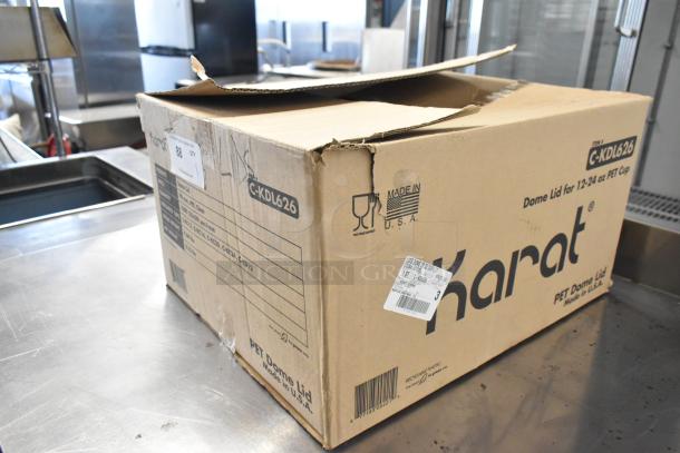 Brand new box of Karat C-KDL626 dome lids for 12-24 oz PET cups. Made in USA. Box slightly open with visible barcode.