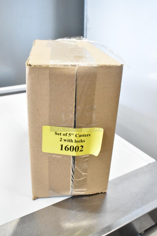 A boxed set of 5" casters, with 2 featuring locks. Label reads "16002." Box sealed with clear tape.