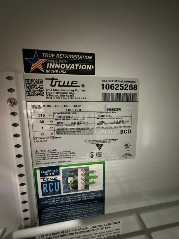 2023 True GDM-43F-HC~TSL01 display freezer label showing model details, 115v, R290 refrigerant, black, dual swing doors.