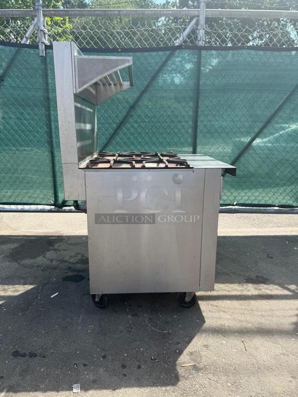 Southbend P32D-XX Platinum 4 Burner Range, 32" wide, 180k BTU, steel, on wheels, used condition, auction label visible.