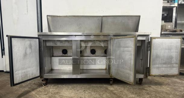 Leader Commercial undercounter 3-door refrigerator, stainless steel, lowboy style, industrial worktop, visible wear, open doors.