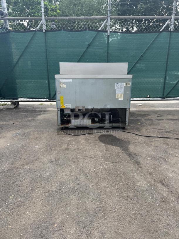 Kelvinator Commercial KCHMT48.18 Mega Top Prep Table, 48", refrigerated base, visible wear, outdoor setting.