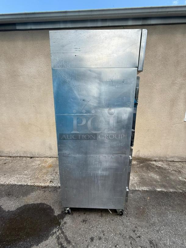 Continental 4-door refrigerator, model 2R-HD, reach-in type, stainless steel, visible wear, mounted on wheels.