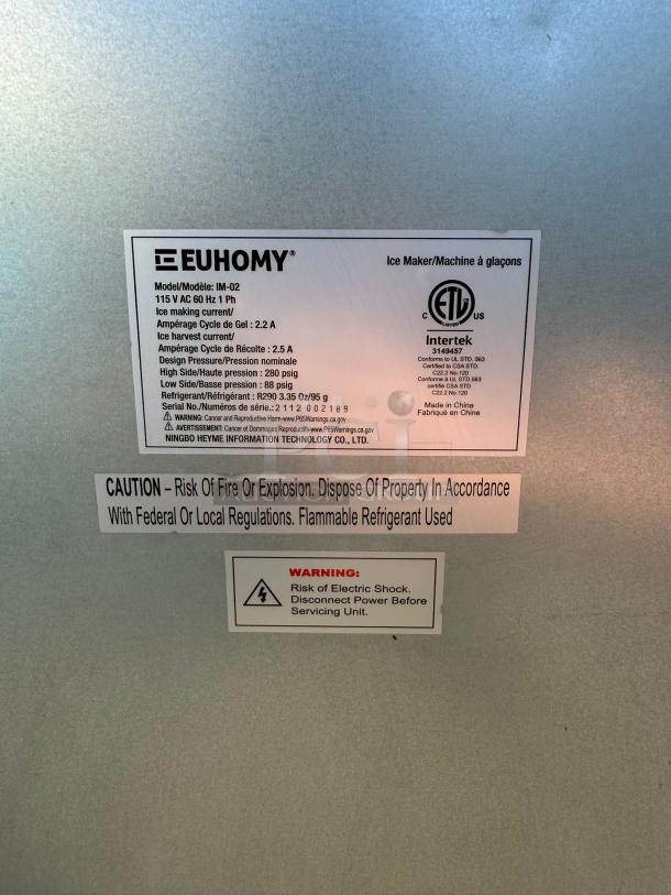 EUHOMY IM-02 Commercial Ice Maker label, stainless steel, 99lbs/day production, 33lbs storage. Caution and warning labels visible.