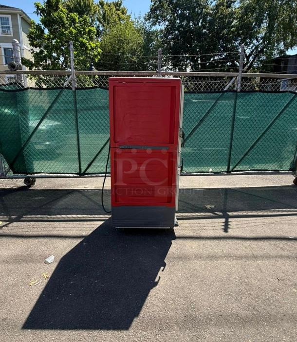 METRO C539-HDS-U full height insulated mobile heated cabinet, 17-pan capacity, red finish, 120v, outdoor setting.