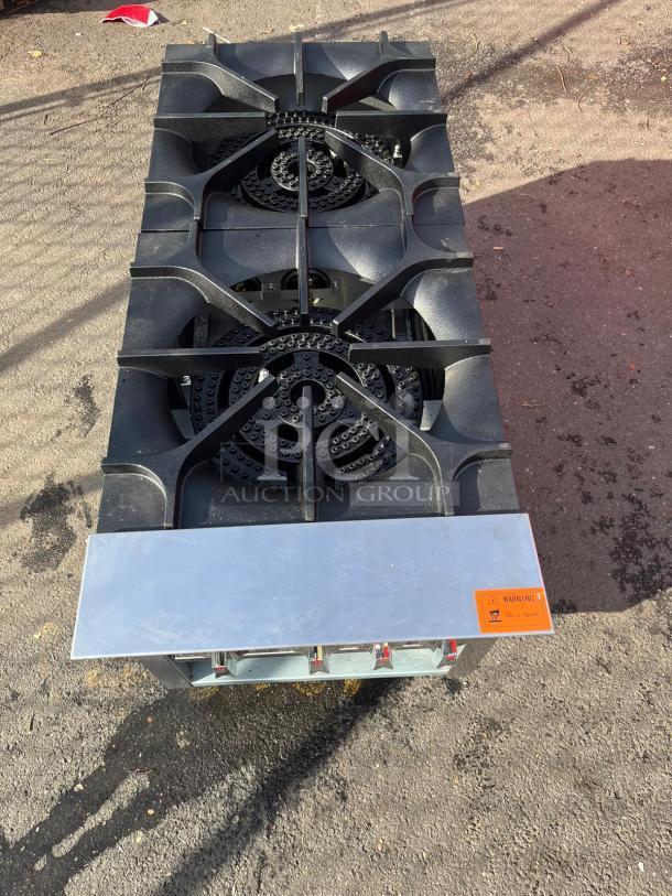 Brand new Dukers DCSPA2 18" cast iron 3-ring burner gas stock pot range, featuring durable construction and high heat output.