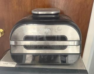 Ninja FG551 Foodi Smart XL 6-in-1 Indoor Grill, stainless steel finish, gently used, visible brand logo on front.